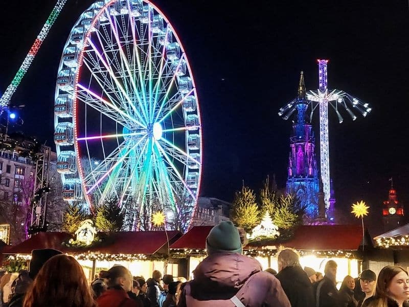 Edinburgh Christmas Market at night with the Big Wheel, Star Flyer and Christmas stalls